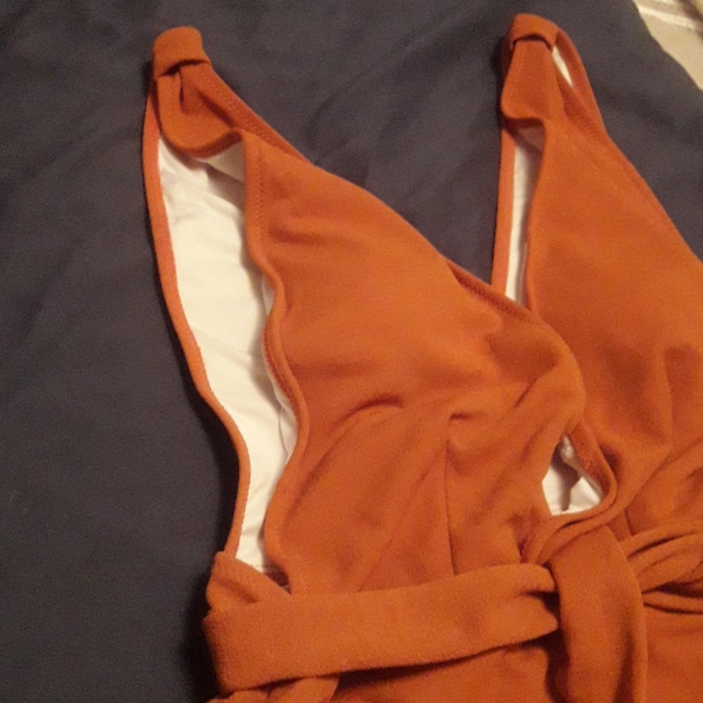 New one PC bathing suit. Burnt orange